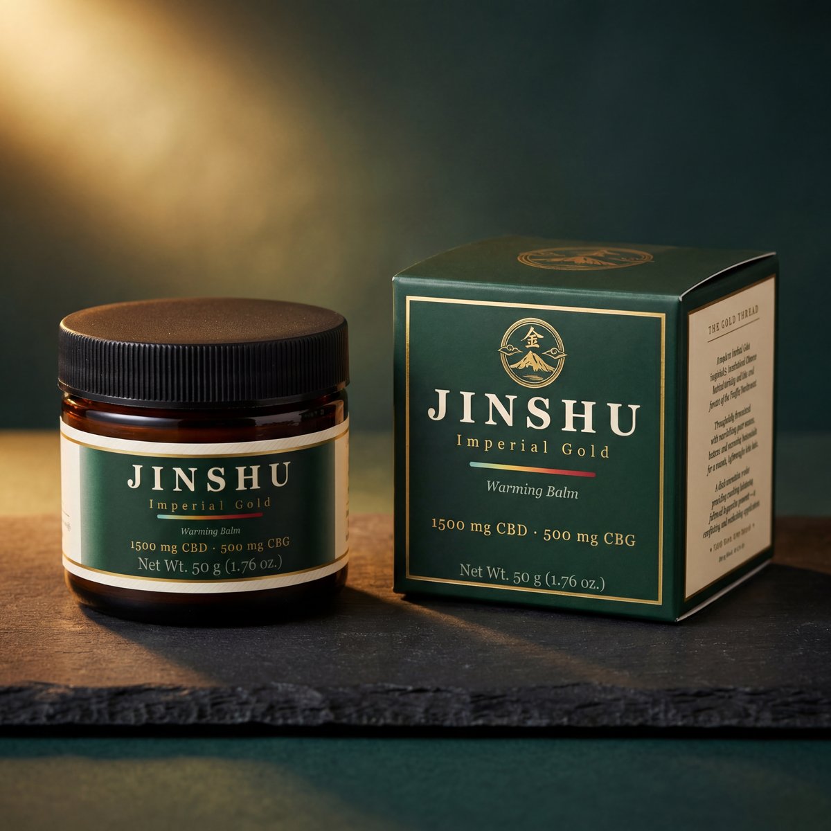 Jinshu Imperial Gold Warming Balm — jar and box on dark slate